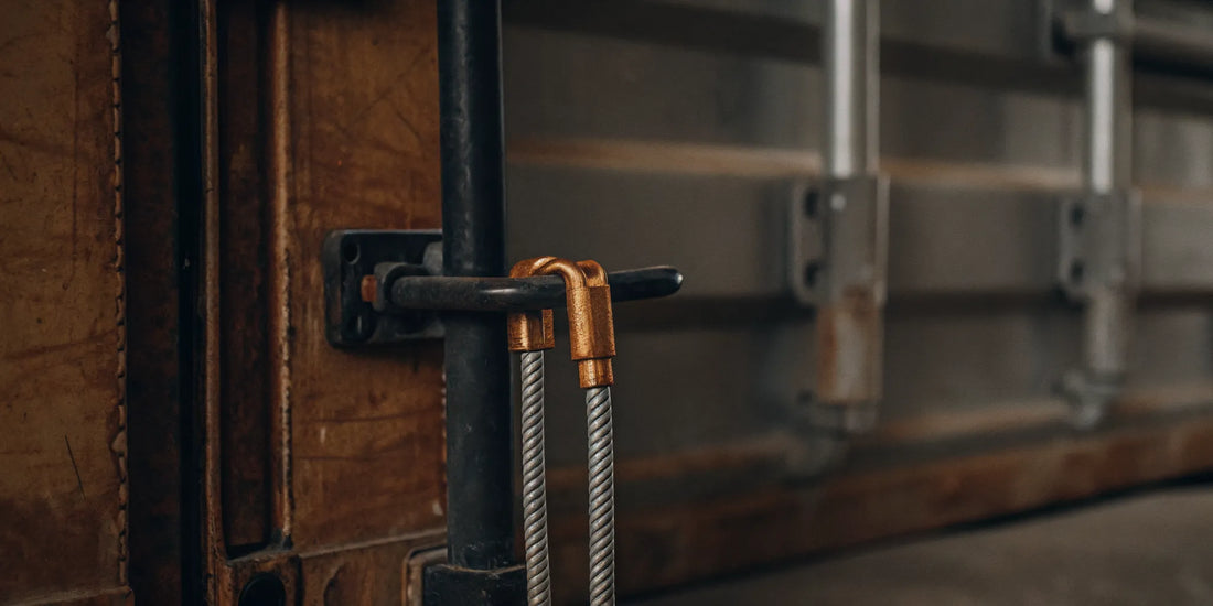 High-security serialized bolt seal on a shipping container door, showing tamper-evident locking mechanism and industrial supply chain security