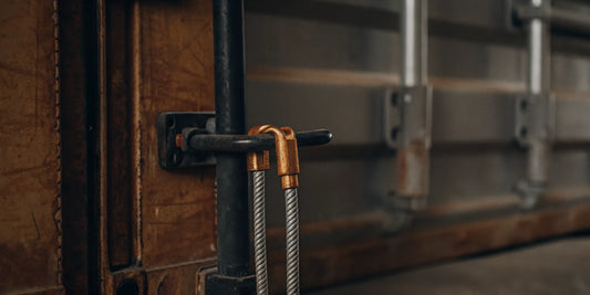 High-security serialized bolt seal on a shipping container door, showing tamper-evident locking mechanism and industrial supply chain security