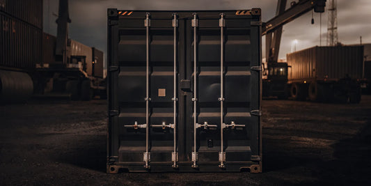 Shipping container with red high-security seal and lock on cargo doors in logistics yard