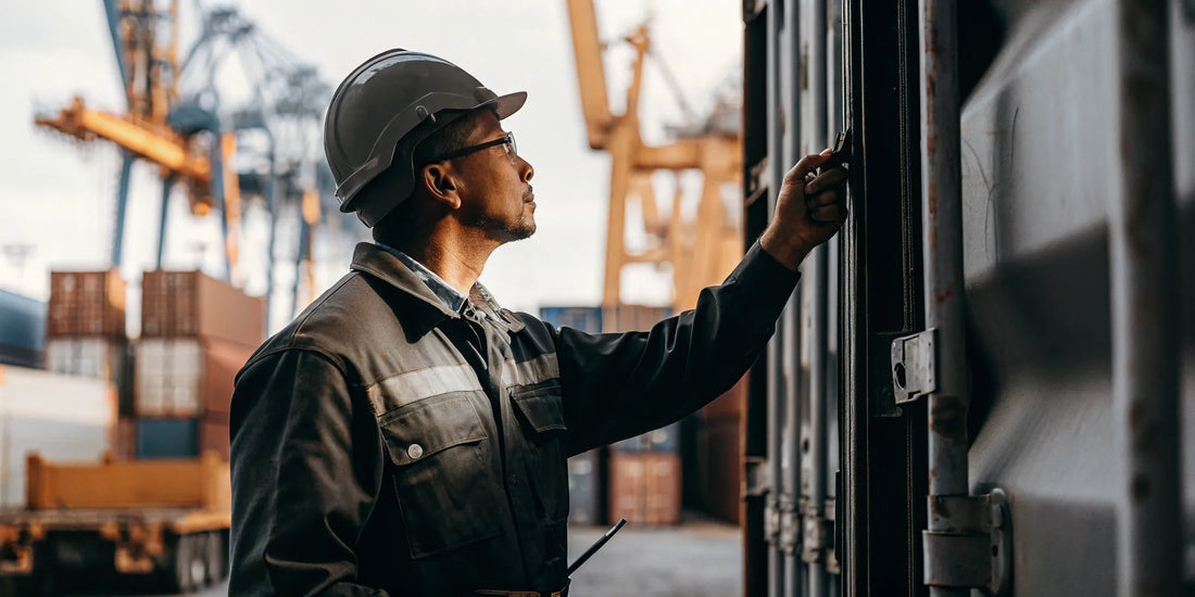 Logistics manager inspecting a cargo container with a high-security bolt seal at a shipping port